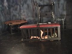 Three lesbians in torture chamber strip and one bends over for spanking