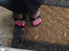 Pink toenails and black stockings with mules