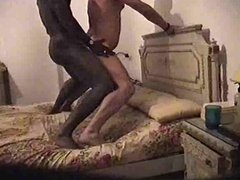 Interracial fuck standing on the bed