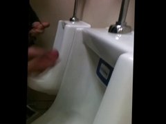 two slim dicks getting wanked at the urinals