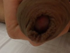 Playing with my foreskin on my hard un-cut cock