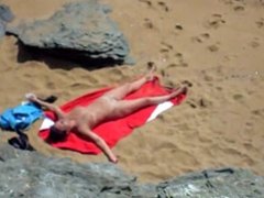 Nude girl on beach sunning.