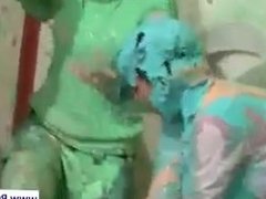Girls spreading paint on their hot bodies