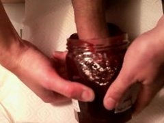 young guy playing with jar of jam