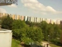 Busty amateur girl shows off on balcony before giving a blowjob
