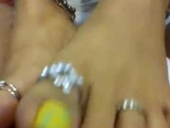 Sexy feet with yellow pedicure and ring give footjob