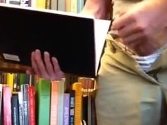 Jacking big cock in the library