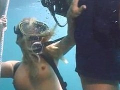 Girl in scuba gear does a blowjob for two divers