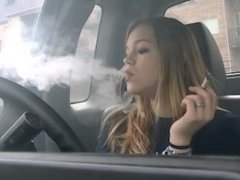 Mika smoking 3 cigarettes in her car - windows up!