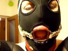 Putting giant penis gag in slave's slut ring gagged mouth