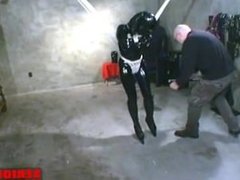 Prisoner trapped in dungeon in straitjacket