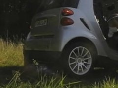 Woman crushes man's hand underneath the wheels of a smart car