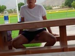 Horny older man shows his big hard cock at public place.