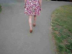 wife walks around the street in her cute summer dress