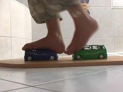 Girls crushing 2 toy cars