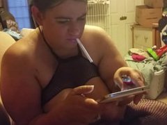wife smoking while playing on her tablet...