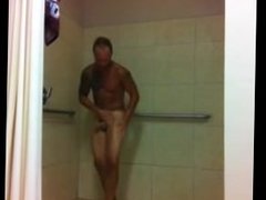 Mature tattoed guy taking a shower