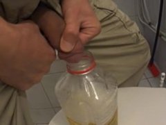 Two friends filling a bottle with their pee