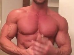 Hot Bodybuilder Muscle Stid Rubs lotion on his ripped muscles