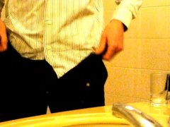 Stripping out of suit and playing with bulge and uncut cock