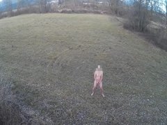 Guy is masturbating naked in open area