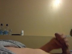 Guy is masturbating his shaved dick while his roommate is in the next room