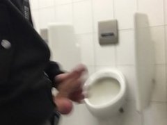 Gay boy is jerking off in public restroom and shoot his load in a urinoir
