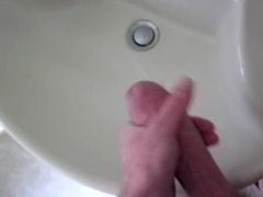 Big fat hairy cock shooting a big load in his sink