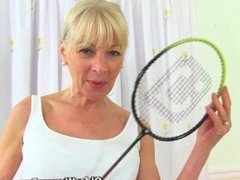 English gilf Elaine sticks a badminton racket up her pussy