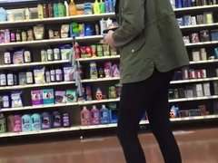 DW Auburn teen with green coat in make-up aisle