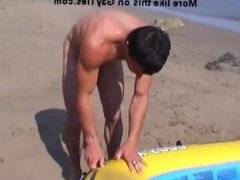 Naked sexy hunk on the beach goes rafting