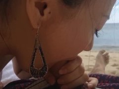 Cute Asian girlfriend sucking on the beach