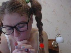 Little Lara makes a deep blowjob with a toy