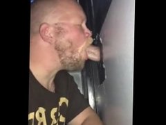 Sexy bear sucking some cock at the gloryhole