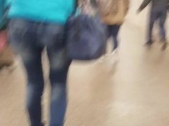 Young woman's small ass in tight jeans