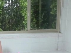 Transbabe jerks cock in bath before pissing