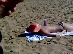 guy jerking off on the beach and cums on the body of a naked