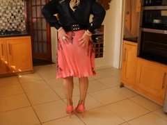 Black blouse and pink pleated skirt