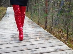 Lady L walking with red extreme sexy boots.