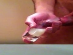 Filling a shotglass with cum