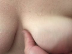 Playing with her beautiful saggy tits while she washes.