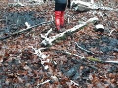 Red PVC thigh high boots and a mini skirt in mud!