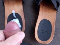 Cumming on black Replay Clogs before giving them away