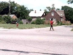 Detroit skinny black Street hooker in red tight mini dress.