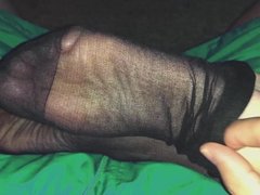 Removing stockings before footfuck