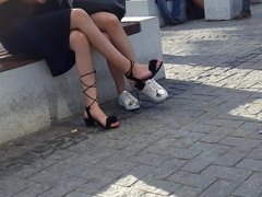 Girls sexy crossed legs, feets in gladiator sandals
